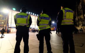 Police officers at the Cologne cathedral and main train station on 31 December 2016 during the New Year's eve.