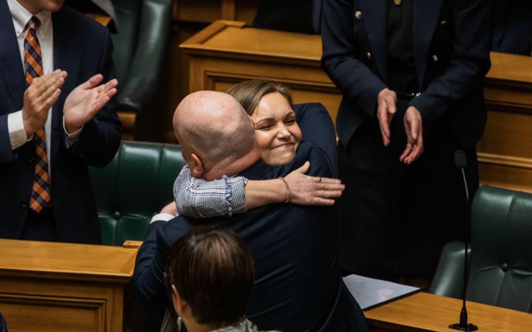 Katie Nimon hugs Prime Minister Christopher Luxon after her maiden speech in the House on 6 December, 2023.