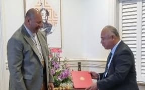 King Tupou VI (L) officially appoints 'Aisake Eke as Tonga's prime minister