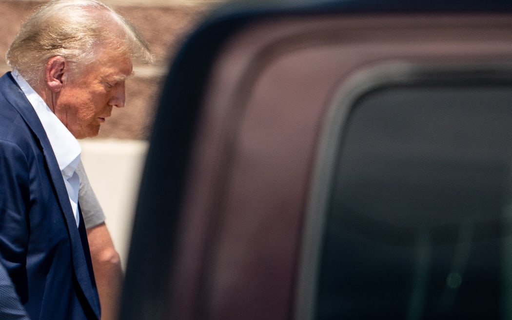 (FILES) Former US President Donald Trump attends the Iowa State Fair in Des Moines, Iowa, on August 12, 2023. Donald Trump was indicted August 14, 2023 on charges of racketeering and a string of election crimes after a sprawling two-year probe into his efforts to overturn his 2020 defeat to Joe Biden in the US state of Georgia, according to a court filing.
The case -- relying on laws typically used to bring down mobsters -- is the fourth targeting the 77-year-old Republican this year and could lead to a watershed moment, the first televised trial of a former president in US history. (Photo by Stefani Reynolds / AFP)