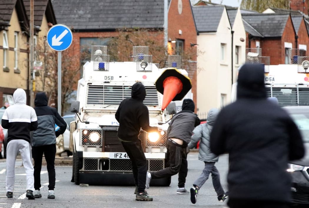 Nationalist youths attack police officers in the Springfield Road area of Belfast on April 8, 2021 as disorder continued in the Northern Ireland capital following days of mainly loyalist violence. -
