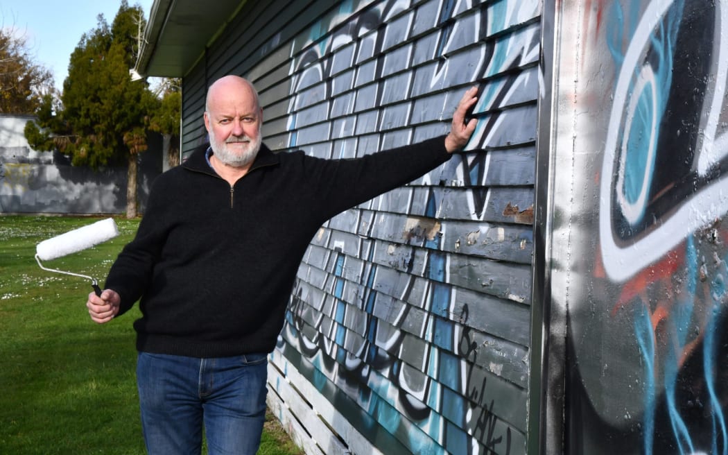 Rotorua Anglers Association president Ron Cole armed to erase the recent graffiti. Photo / Laura Smith