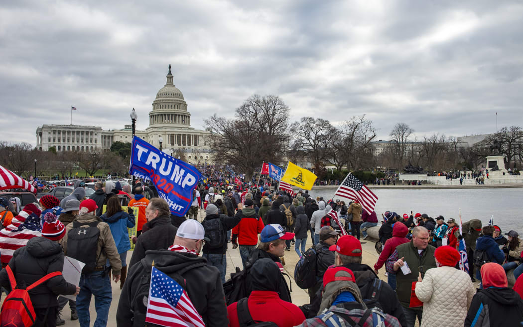Supporters of US President Donald Trump march through the streets of the city as they make their way to the Capitol Building in Washington DC on January 6, 2021. -
