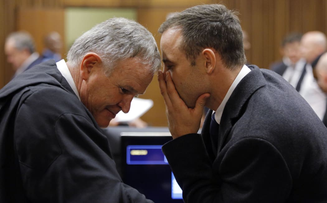 Lawyer Barry Roux and Oscar Pistorius confer.