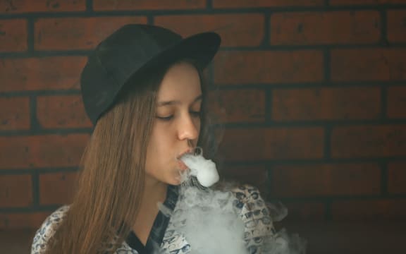 A teenager vapes.