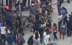 Television news footage earlier in the day showed caravans of unmarked military-style vehicles and vans loaded with uniformed federal agents streaming through Los Angeles streets as part of the immigration enforcement operation.