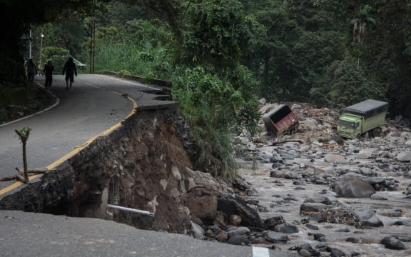 A damaged road is seen after flash floods and cold lava flow from a volcano in Tanah Datar, West Sumatra, on May 12, 2024. At least 34 people have died and 16 more were missing after flash floods and cold lava flow from a volcano hit western Indonesia, a local disaster official said on May 12. (Photo by REZAN SOLEH / AFP)