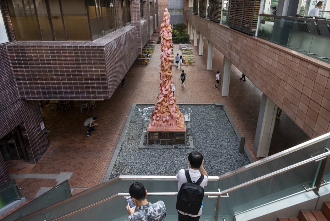 Visitors look at the eight-meter 'Pillar of Shame' statue that commemorates the victims of the 1989 Tiananmen Square crackdown in Beijing, at the University of Hong Kong (HKU) in Hong Kong, on 11 October, 2021.