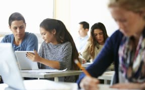 High school students with laptops and digital tablets