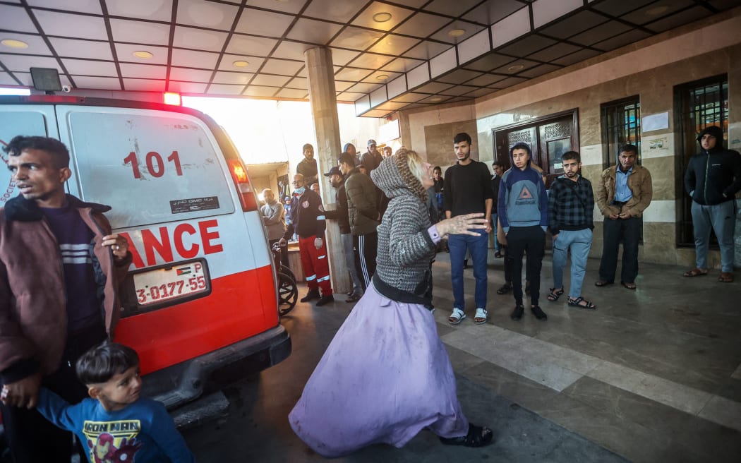 (FILES) A woman reacts as injured Palestinians are brought to Nasser hospital in Khan Yunis in the southern Gaza Strip following Israeli bombardment on December 15, 2023. Medics are sounding the alarm at southern Gaza's Nasser hospital, where a nurse said snipers are killing people, sewage has flooded the emergency room and drinking water has run out.