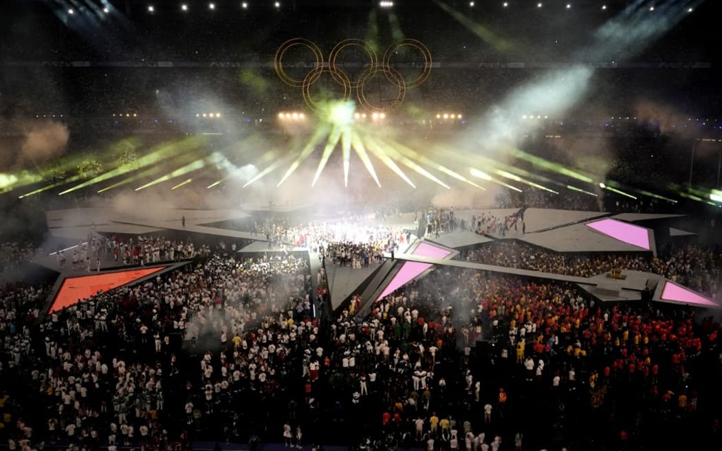 Athletes celebrate during show of the closing ceremony of the Paris 2024 Olympic Games at the Stade de France, in Saint-Denis, in the outskirts of Paris, on August 11, 2024. (Photo by Dimitar DILKOFF / AFP)