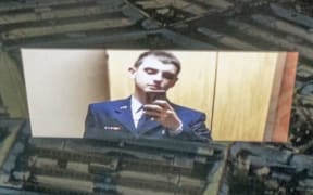 This photo illustration created on April 13, 2023, shows the suspect, national guardsman Jack Teixeira, reflected in an image of the Pentagon in Washington, DC. - FBI agents on Thursday arrested a young national guardsman suspected of being behind a major leak of sensitive US government secrets -- including about the Ukraine war. US Attorney General Merrick Garland announced the arrest made "in connection with an investigation into alleged unauthorized removal, retention and transmission of classified national defense information." (Photo by Stefani REYNOLDS / AFP)