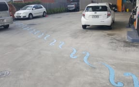 The route of the Waimapihi Stream, which starts in the Aro Valley and runs underground through central Wellington, is marked out on a service station forecourt.