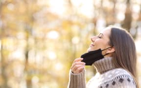 Breathing outdoors wearing mask.
