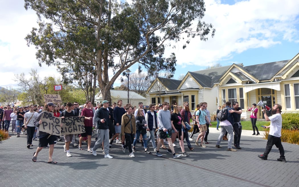 Students march against the proctor's actions.