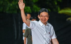 Singapore's Prime Minister Lawrence Wong of the People's Action Party (PAP) gestures as he arrives at the party's gathering awaiting the vote count for the general election in Singapore on May 3, 2025. Singapore's ruling party headed for a crushing victory at general elections on May 3, sample counts showed, with voters giving Prime Minister Lawrence Wong the clear mandate he was seeking. (Photo by Roslan RAHMAN / AFP)