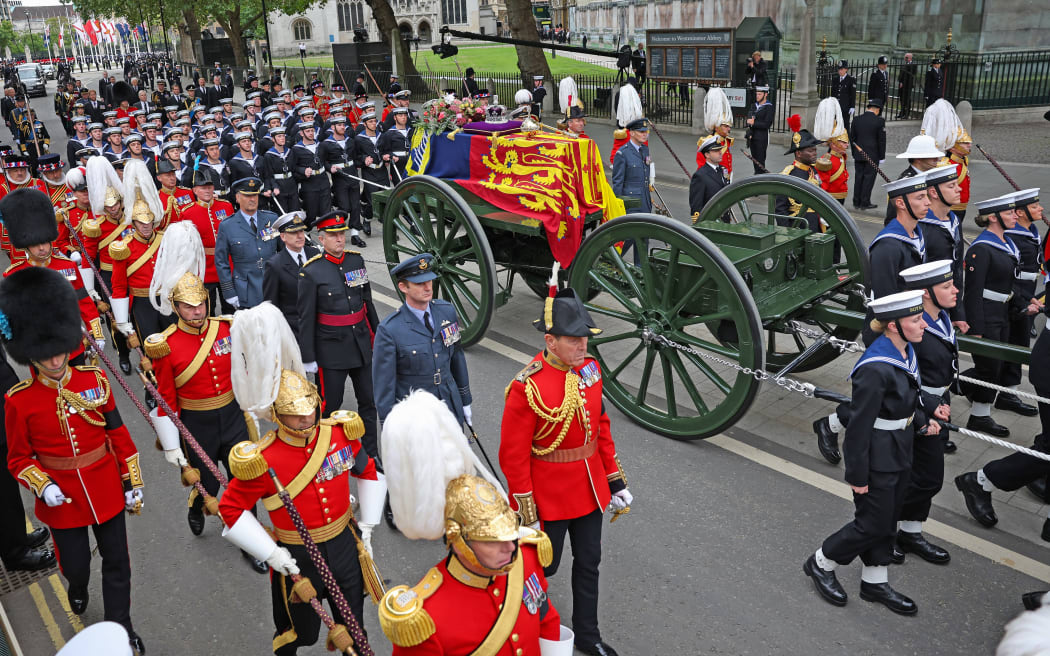 The State Gun Carriage carries the coffin of Queen Elizabeth II, draped in the Royal Standard with the Imperial State Crown and the Sovereign's orb and sceptre, as it makes its way for the State Funeral at Westminster Abbey, London on September 19, 2022.