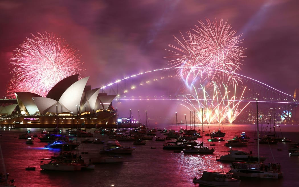 Sydney's 'family fireworks', displayed three hours before midnight every year ahead of the main show at midnight, fill the sky over the Opera House in Sydney on New Year's Eve on 31 December, 2022.