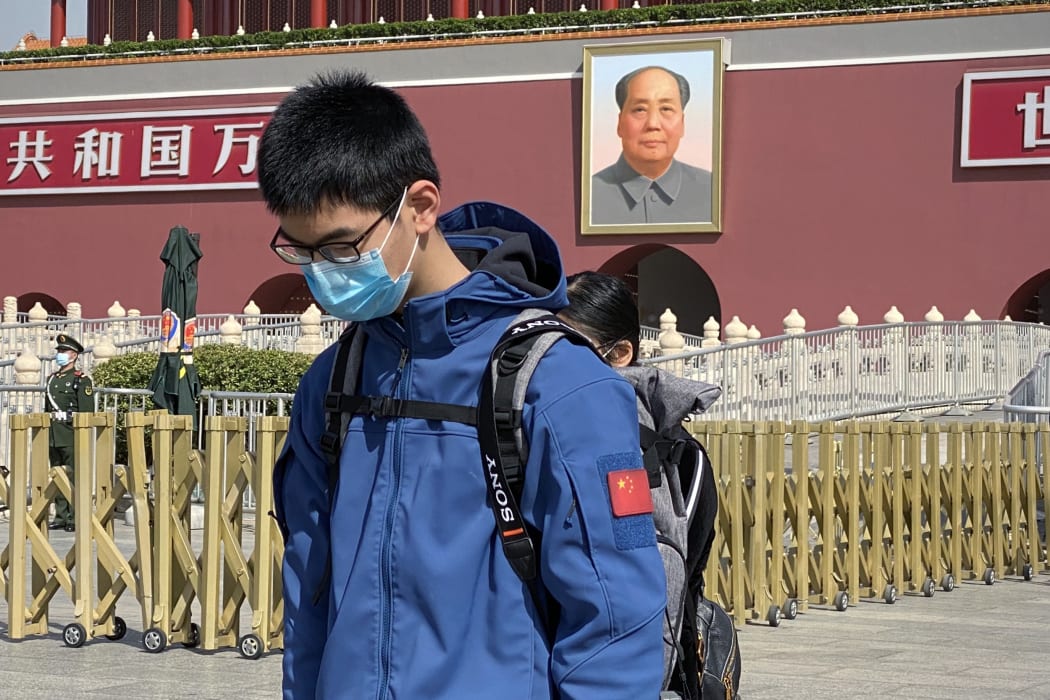 A man bows in front of Tiananmen Gate during a three minute national memorial to commemorate people who died in the COVID-19 coronavirus outbreak.