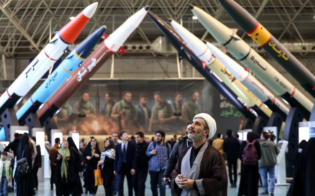 Iranians visit an exhibition showcasing missile and drone achievements in Tehran on November 12, 2025. (Photo by ATTA KENARE / AFP)