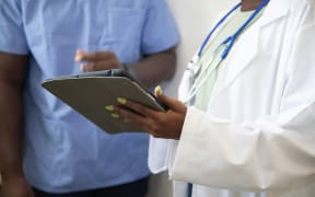 Medical staff are seen wearing scrubs, and a stethoscope.