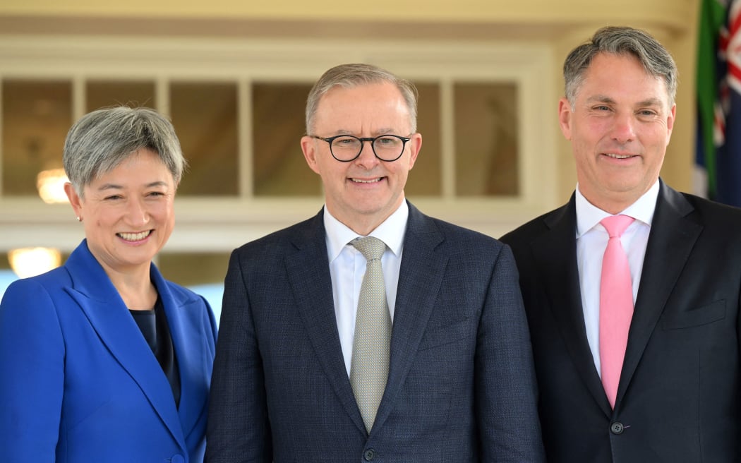 Australia's new Prime Minister Anthony Albanese (C) poses with his new cabinet ministers, Penny Wong (L) and Richard Marles after the oath taking ceremony at Government House in Canberra on May 23, 2022. (Photo by SAEED KHAN / AFP)