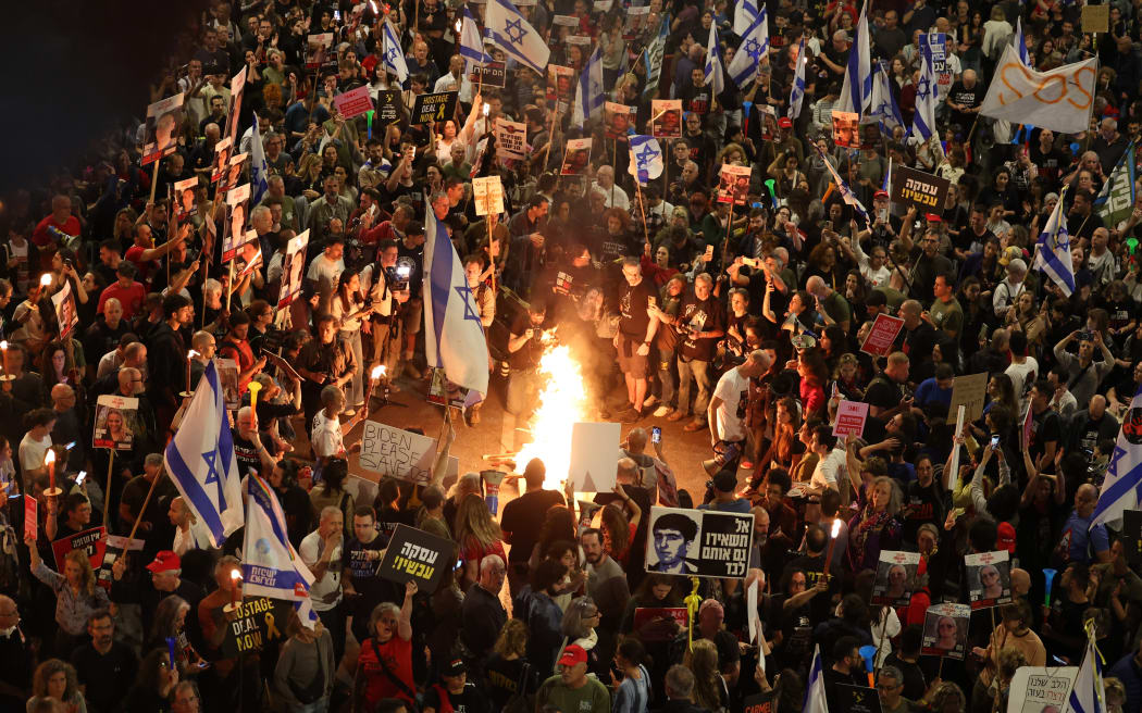 Protesters carry placards during a gathering by relatives of Israeli hostages held in Gaza since the October 7 attacks by Hamas militants, in front of the Defense Ministry in the Israeli coastal city of Tel Aviv, on March 30, 2024, amid the ongoing conflict in the Gaza Strip between Israel and the Palestinian militant Hamas movement. (Photo by JACK GUEZ / AFP)
