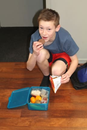 An image of Daniel Bridgman grabbing a quick snack during dance rehearsals.