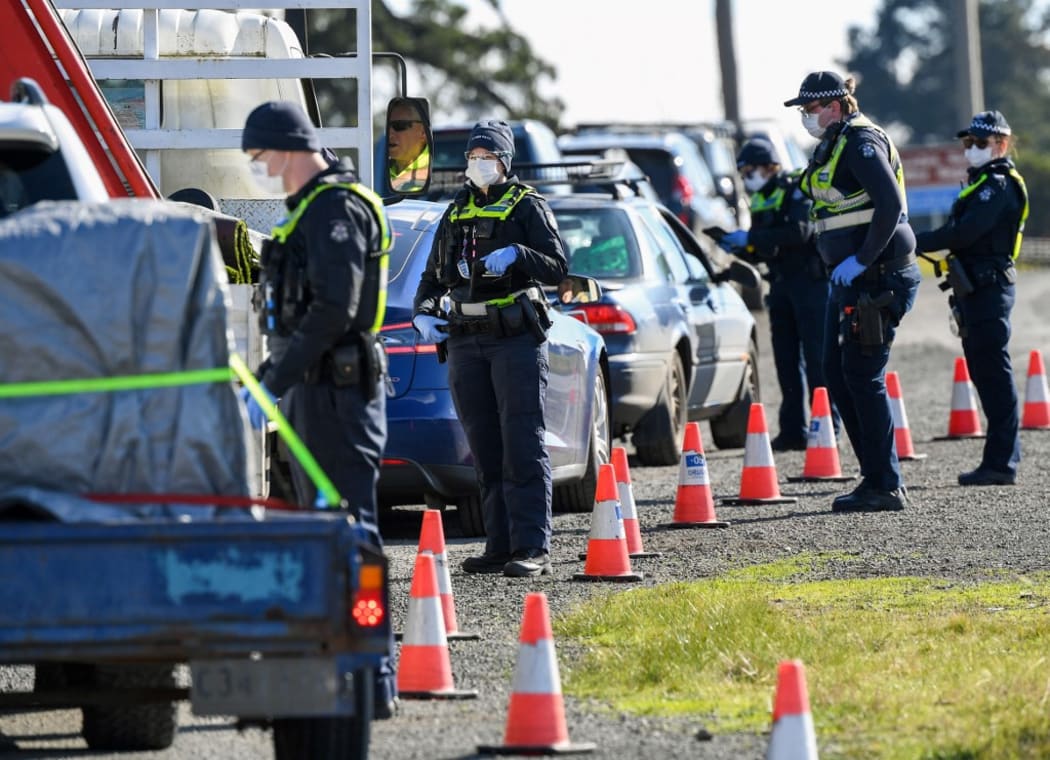 Police conduct roadside checks on the outskirts of Melbourne on July  9, 2020 on the first day of the city's new lockdown.