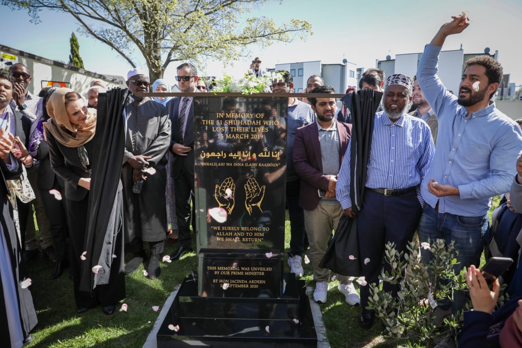 One of the Muslims attending the plaque unveiling throws flowers to commemorate the unveiling with the prime minister on 24 September, 2020.