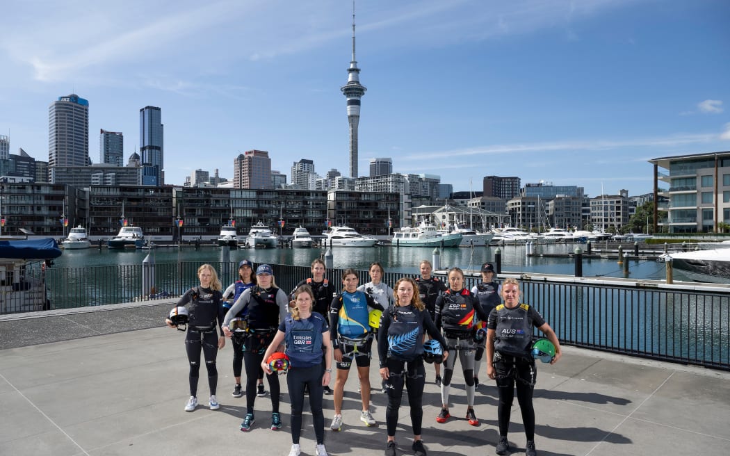 (L-R) Anna Barth, strategist of Germany SailGP Team, Giulia Fava, strategist of Red Bull Italy SailGP Team, Anna Weis, grinder and jib trimmer of USA SailGP Team, Hannah Mills, strategist of Emirates Great Britain SailGP Team, Maud Jayet, strategist of Switzerland SailGP Team, Martine Grael, driver of Mubadala Brazil SailGP Team, Manon Audinet, strategist of France SailGP Team, Liv Mackay, strategist of New Zealand SailGP Team, Anne-Marie Rindom, strategist of ROCKWOOL Denmark SailGP Team, Nicole van der Velden, strategist of Spain SailGP Team, Annie Haegar, strategist of Canada NorthStar SailGP Team and Natasha Bryant, strategist of Australia SailGP Team in front of the city skyline ahead of The Rolex SailGP 2025 Championship ITM New Zealand Sail Grand Prix in Auckland, New Zealand. Thursday 16 January 2025. Photo: Ricardo Pinto for SailGP. Handout image supplied by SailGP