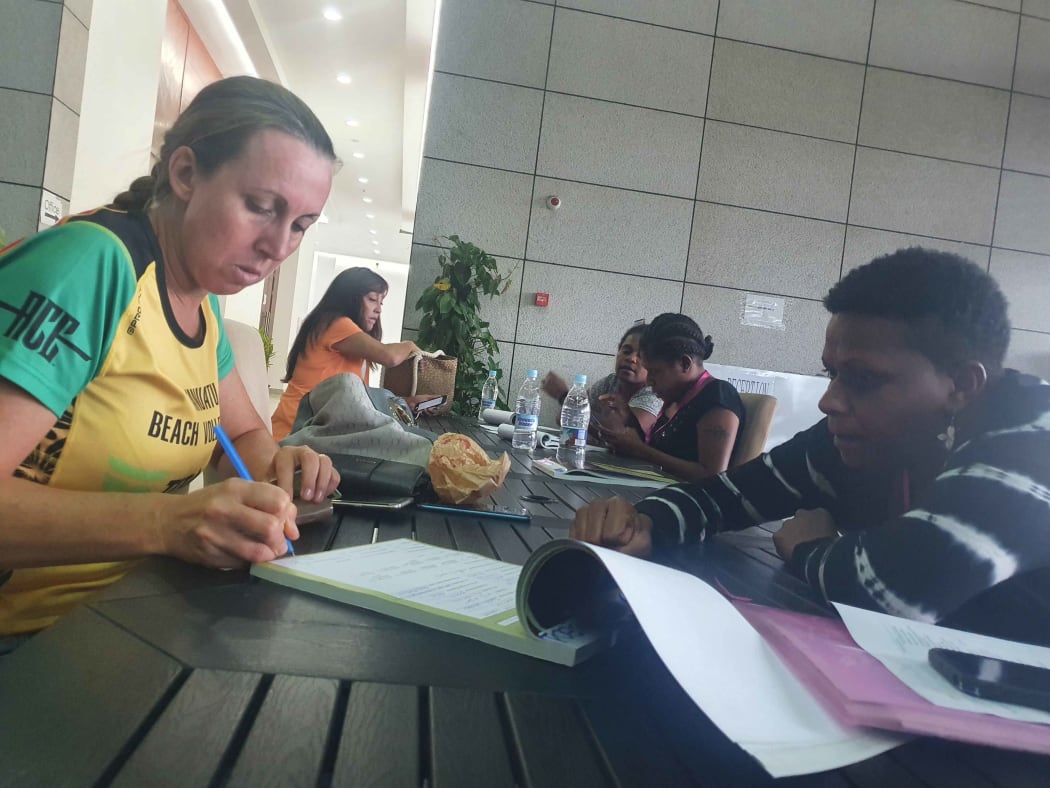 Vanuatu Beach Volleyball President Debbie Masauvakalo  (L) registers for the vaccine.
