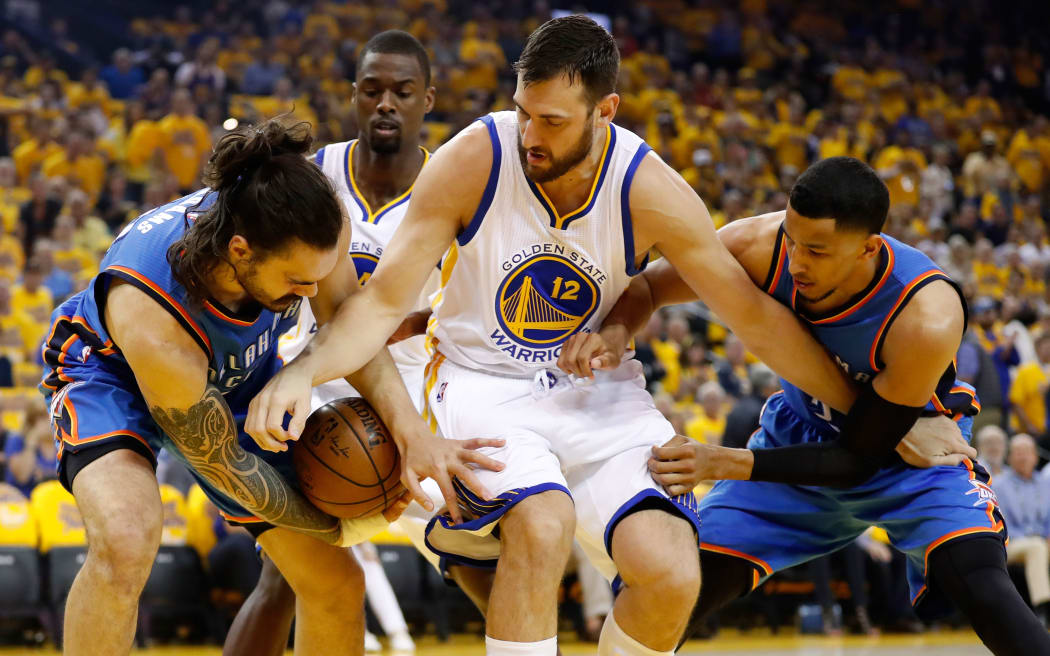 Steven Adams wrestles the ball off Golden State center Andrew Bogut.