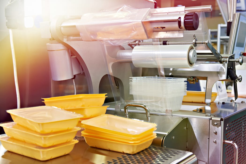 Industrial equipment for food packaging in factory.