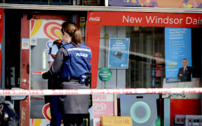 Police officers outside the New Windsor Dairy in Auckland on 5 October 2023.