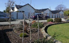 The couple who lived next door to the Dickason family have planted a memorial in their garden to remember the three girls who were killed.