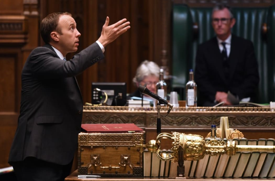 A handout photograph released by the UK Parliament shows Britain's Health Secretary Matt Hancock speaking in the House of Commons in London .