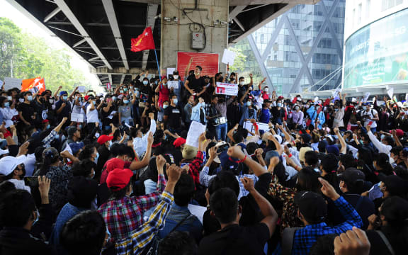 People holding placards shout slogans of anti-coup as they protest against the military coup.