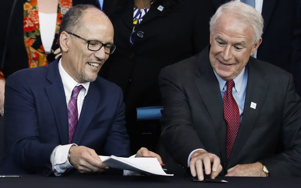 Milwaukee Mayor Tom Barrett (R) and Chair of the Democratic National Committee Tom Perez  sign a document announcing the selection of Milwaukee as the 2020 Democratic National Convention host city during a press conference at the Fiserv Forum in Milwaukee, Wisconsin on March 11, 2019.