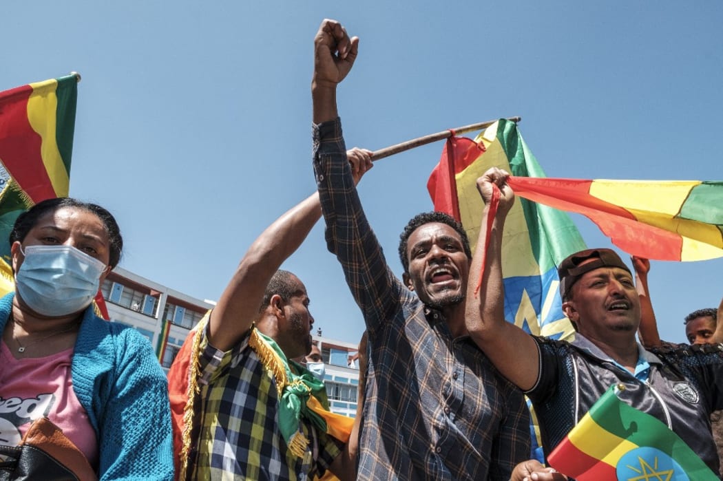 People carry Amhara flags and Ethiopia national flags in the streets after a national call to stand in honour of the Ethiopian National Defence Forces, in Addis Ababa, on November 17, 2020.