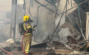 Handout picture released by Rio Grande do Sul Fire Department showing firefighters working on the site of a plane crash in Gramado, Rio Grande do Sul, Brazil on 22 December, 2024.