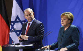 Benjamin Netanyahu and Angela Merkel addressing a media conference in Berlin.