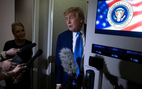US President Donald Trump speaks to reporters about the G7 Summit aboard Air Force One while travelling back to Washington from Canada on 16 June 2025.