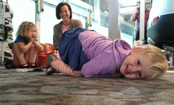 Zoe Psirides (front), Lilly Psirides and mum Sally Huford waiting at the airport on Thursday.