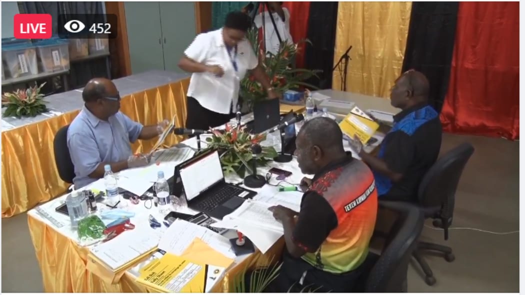 An action shot of election officials counting Vanuatu's election results.