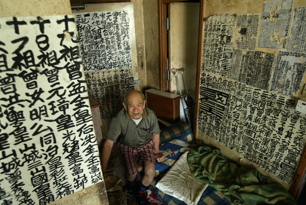 Graffiti painter Tsang Tsou-choi, known as King of Kowloon, pictured in 2003 with his works.