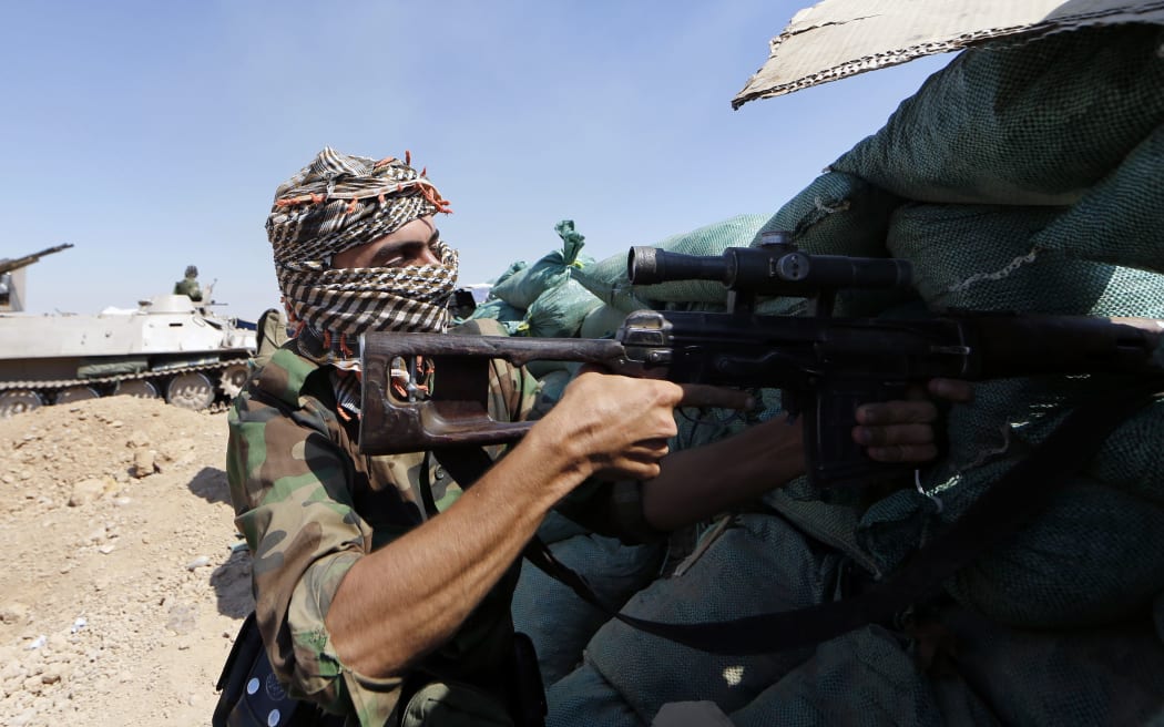 Iraqi Kurdish forces near Taza Khormato fight ISIS militants in Bashir, near Kirkuk, on Monday.