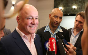 Tama Potaka speaks to reporters with National Party leader Christopher Luxon after the preliminary results are counted.