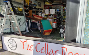 The front of The Cellar Room bottle shop in Brooklyn, Wellington, was smashed in a raid.