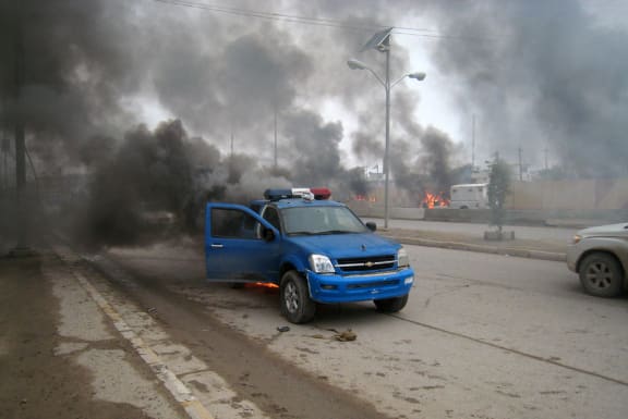 A burning police car in Ramadi.